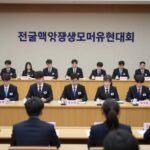 전국대학생모의유엔대회 공식회의 장면, 정장을 입은 대학생들이 국가명패 앞에 앉아 회의에 참여하고 있다